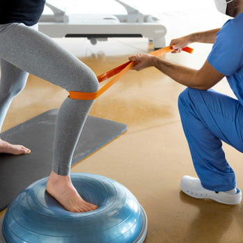 physical therapist works with a patient to help with improving mobility and balance