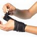 person tightening thumb strap on BioSkin Thumb Spint