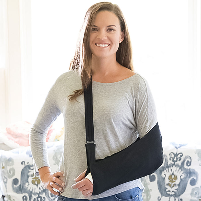 woman wearing the Brownmed Joslin Ultimate Arm Sling on her left arm