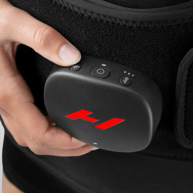 woman adjusting the settings on her Hyperice Venom 2 Back Heat and Massage Wrap