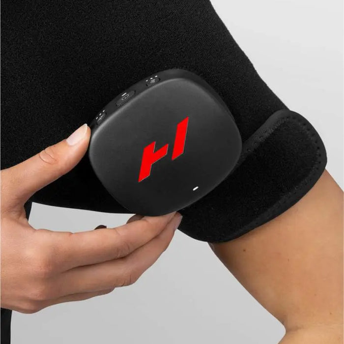 woman adjusting the settings on her Hyperice Venom 2 Shoulder Heat and Massage Wrap