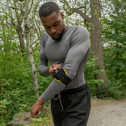 man adjusting the M-Brace Epicondylitis Brace