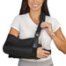 woman adjusting the shoulder strap on the Med Spec Outrigger II Shoulder Immobilizer