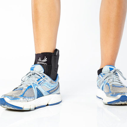 person wearing BioSkin Premium Ankle Compression Brace with sneakers