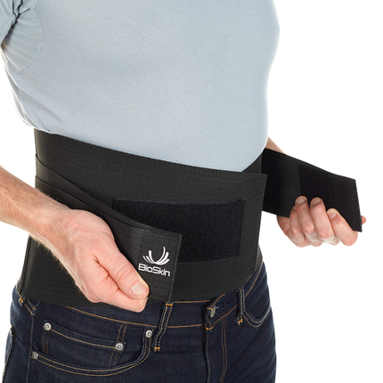 man adjusting Bioskin Lumbar Compression Wrap