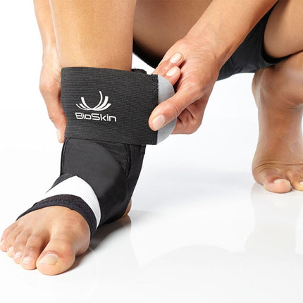 person adjusting BioSkin TriLok Ankle Brace