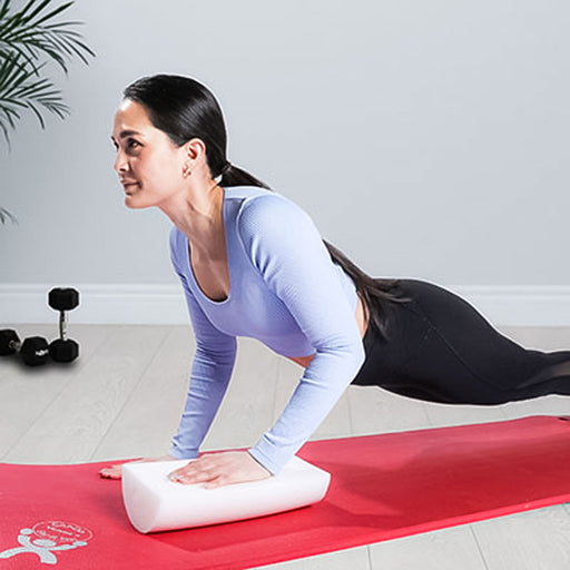 woman using CanDo Half Round Foam Roll 12in for push-ups