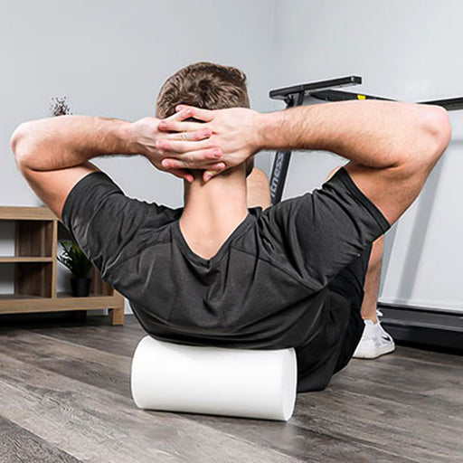 man using CanDo White Round PE Foam Roller for crunches