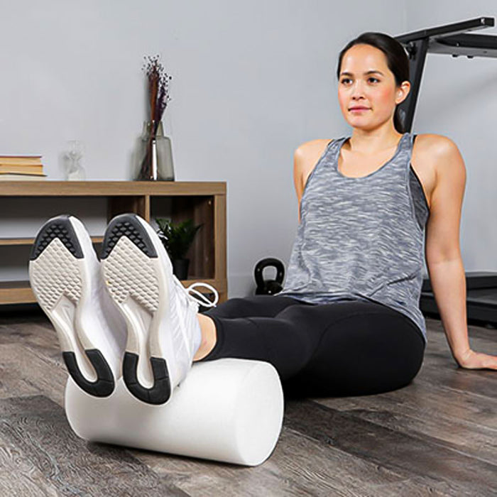 woman using CanDo White Round PE Foam Roller to stretch her calves