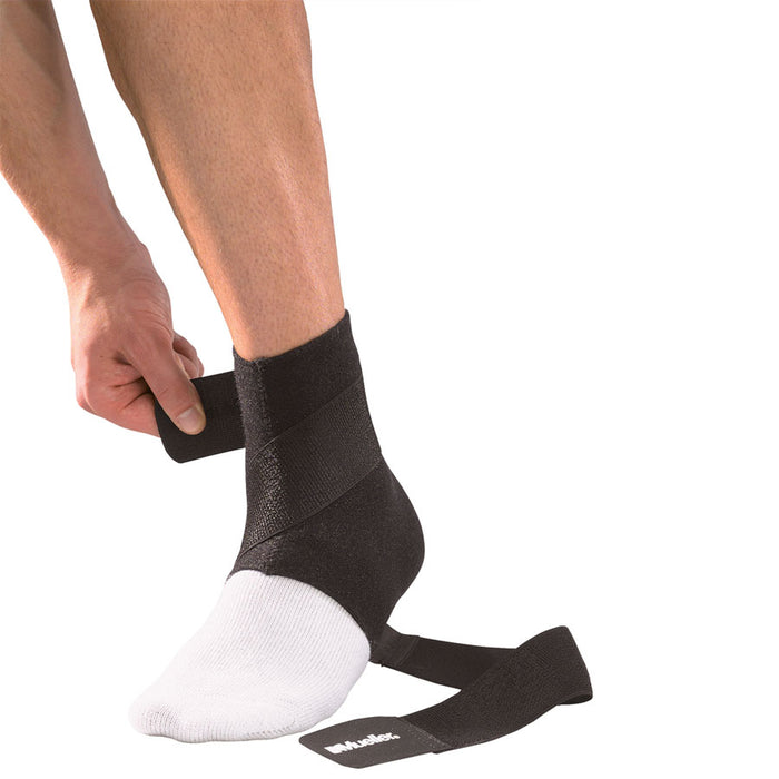 person adjusting the Mueller Ankle Support with Straps