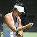 Woman tennis player adjusting fit of ProBand BandIT on her forearm